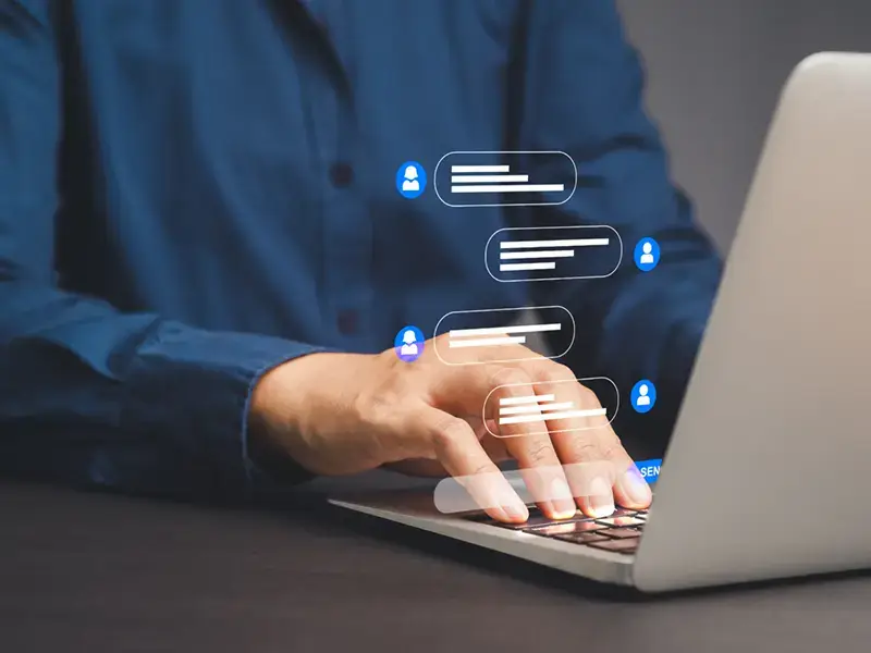 Businesswoman typing on a laptop with live chat on application communication.